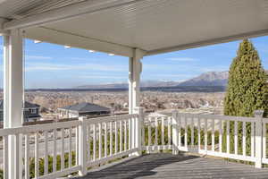 Wooden terrace featuring a residential view and a mountain view