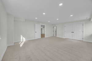 Empty room featuring recessed lighting, baseboards, and light colored carpet