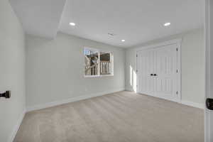 Unfurnished bedroom with visible vents, recessed lighting, a closet, carpet floors, and baseboards