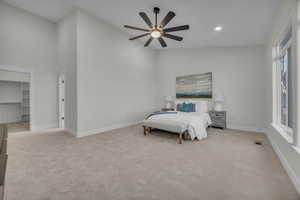 Bedroom featuring a spacious closet, visible vents, baseboards, and carpet floors