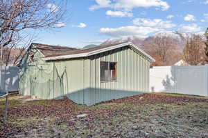 View of side of property featuring a mountain view and fence
