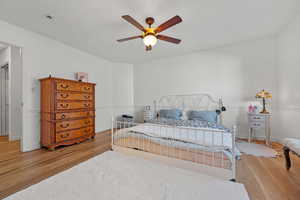Bedroom with baseboards, a ceiling fan, and wood finished floors