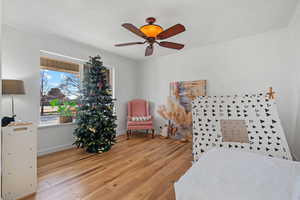 Bedroom with crown molding and light wood finished floors