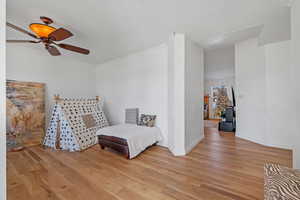 Living area with light wood-style flooring, baseboards, and ornamental molding
