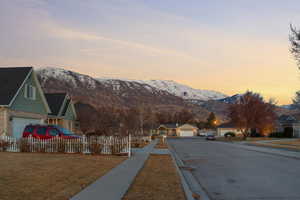 View of street featuring a residential view, curbs, a mountain view, and sidewalks