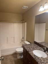 Full bathroom with shower / bathing tub combination, toilet, vanity, visible vents, and tile patterned flooring