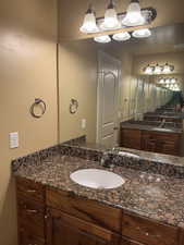 Bathroom featuring vanity, visible vents, and a chandelier