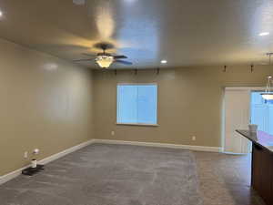 Spare room with baseboards, recessed lighting, ceiling fan, and a textured ceiling