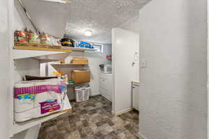 Interior space featuring baseboards, a textured ceiling, and a textured wall