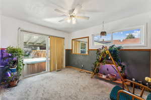 Recreation room featuring visible vents, ceiling fan, and carpet floors