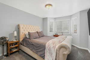 Bedroom with baseboards and new carpet