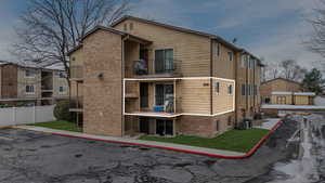 View of building exterior with cooling unit and fence