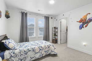 Bedroom featuring visible vents, baseboards, and carpet flooring