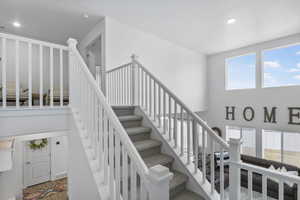 Stairway featuring visible vents, recessed lighting, and wood finished floors
