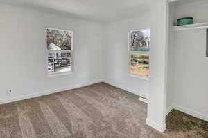 Empty room with baseboards and carpet floors