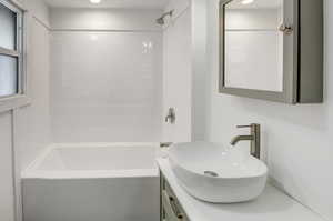 Full bath with bathing tub / shower combination and vanity