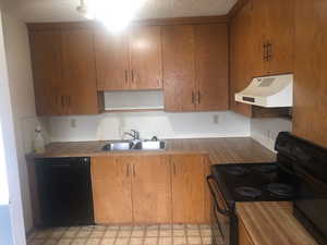 Kitchen featuring a sink, ventilation hood, a textured ceiling, black appliances, and open shelves