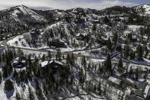 Snowy aerial view with a mountain view and a residential view