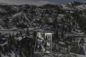 Snowy aerial view featuring a mountain view