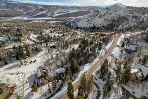 Snowy aerial view featuring a mountain view