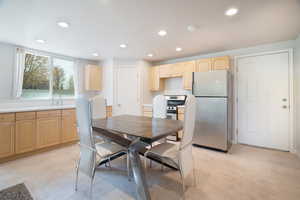 Dining room featuring recessed lighting, stainless appliances, and basement own kitchen