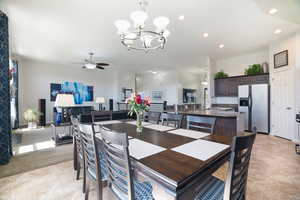 Dining area featuring recessed lighting and ceiling fan with notable chandelier