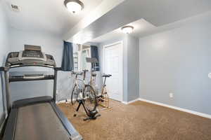 Workout room or extra bedroom with baseboards, visible vents, and carpet