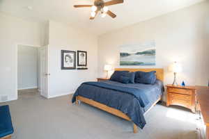 Main Bedroom, carpeted, featuring visible vents, ceiling fan, and baseboards with plenty of room
