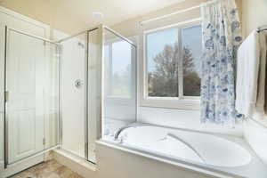 Main Bathroom with a bath, a shower stall, a wealth of natural light, and tile patterned floors