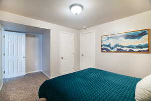 Carpeted bedroom featuring baseboards and two tone paint