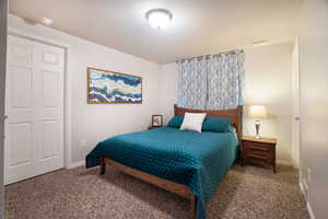 Bedroom featuring baseboards and carpet floors
