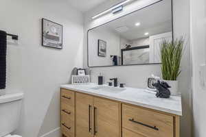 Main level hallway full bathroom luxury vanity, mirror, lighting and finishes.