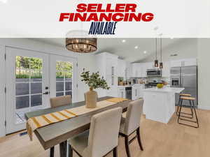 Dining room featuring recessed lighting, light wood-type flooring, a chandelier, french doors, and high vaulted ceiling