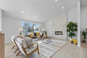 Main living area featuring recessed lighting, lvp flooring, vaulted ceilings, and gas fireplace.