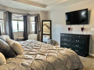 Bedroom featuring baseboards and light carpet