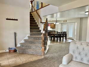 Stairway featuring tile patterned floors and baseboards