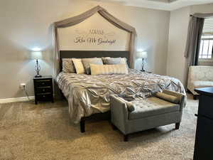 Carpeted bedroom featuring baseboards