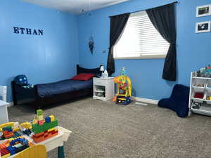 Carpeted bedroom featuring visible vents and baseboards