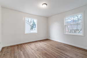 Empty room featuring baseboards and wood finished floors