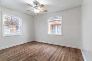 Unfurnished room featuring ceiling fan, baseboards, and wood finished floors