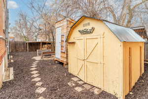 View of shed with a fenced backyard