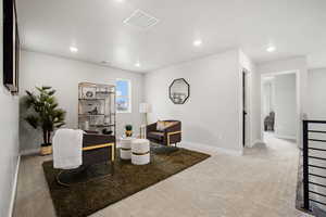 Living area with visible vents, recessed lighting, baseboards, and carpet