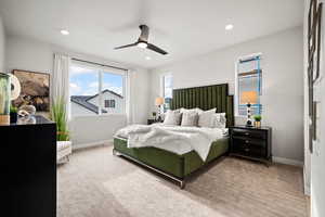 Carpeted bedroom featuring a ceiling fan, recessed lighting, and baseboards