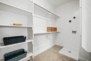 Walk in closet with carpet flooring