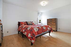 Bedroom with light wood flooring