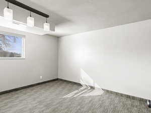 Carpeted spare room with baseboards