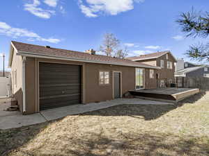 Back of property featuring central air condition unit, fence, roof with shingles, and stucco siding