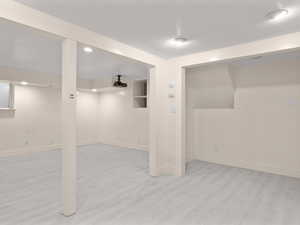Finished basement with baseboards and wood finished floors