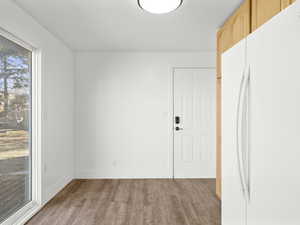 Spare room with baseboards and light wood finished floors