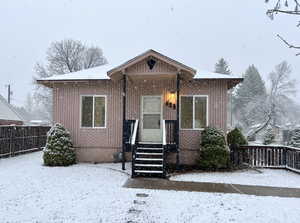 Bungalow-style house with fence